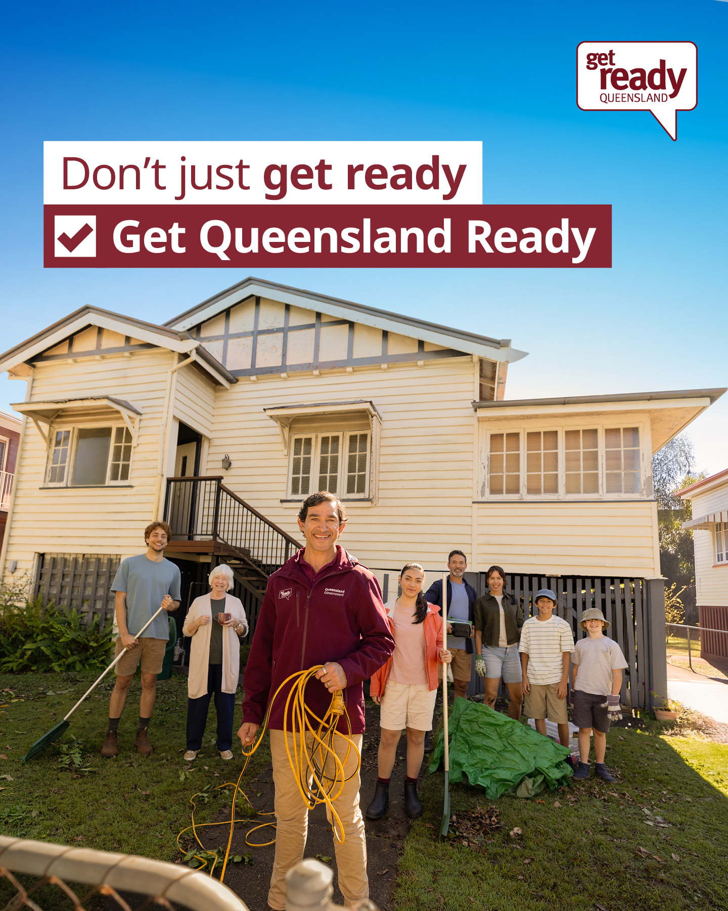 Group of people stand infront of a house smiling 
