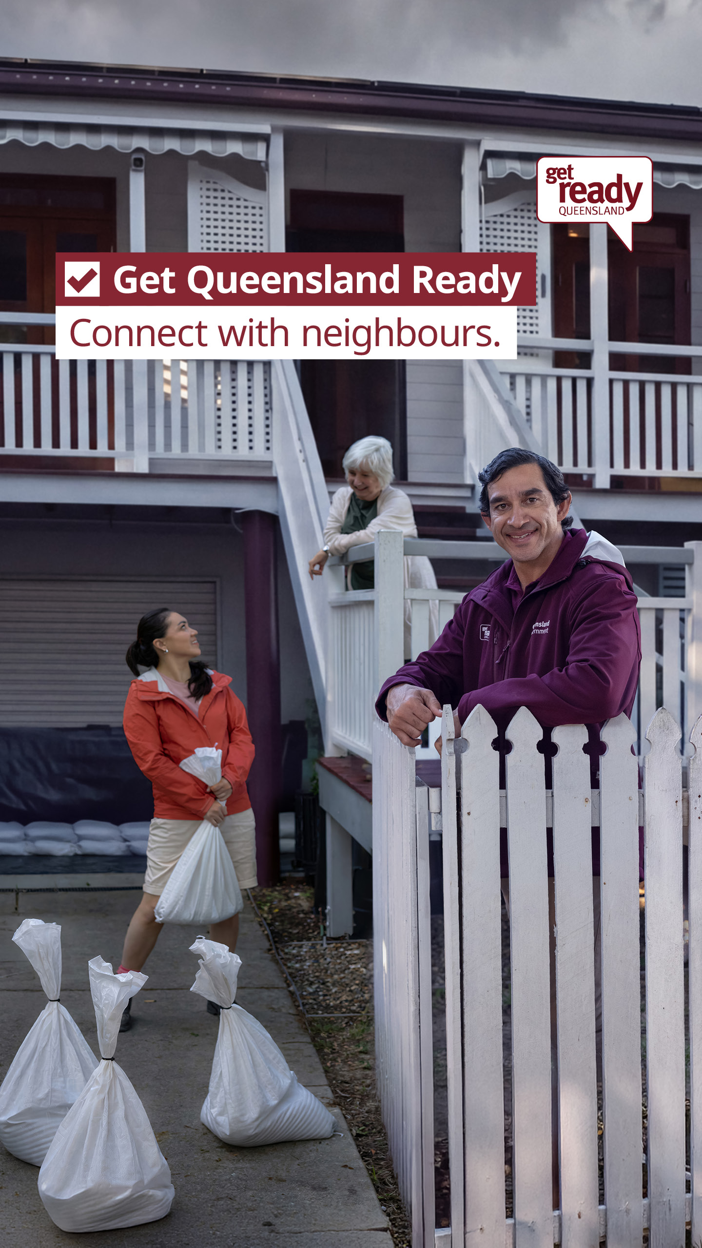 Promotional poster for Get Ready Queensland, 3 people at the front of a house one preparing a sandbag flood water diversion