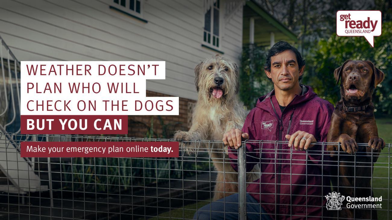 Weather doesn't plan who will check on the dogs - Johnathan Thurston leaning on a fence with two dogs either side of him.