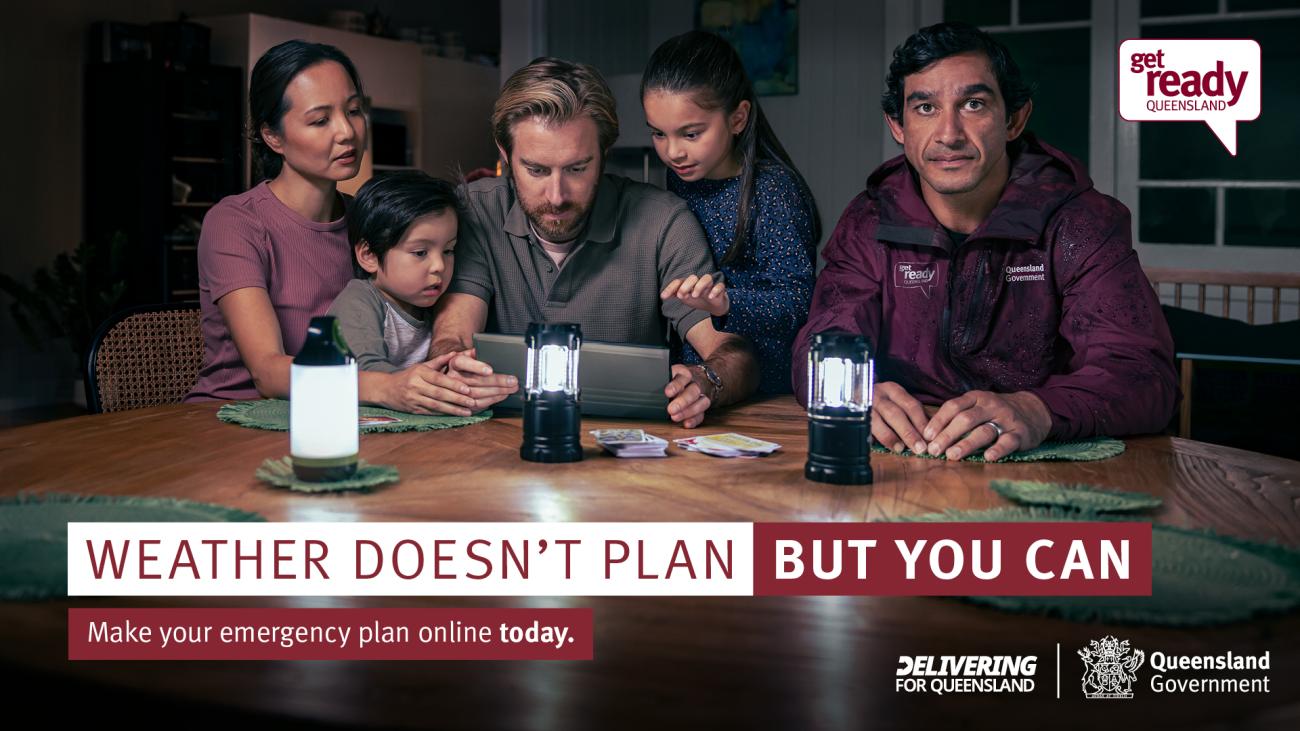 Family sat at a table at night with batter lamps giving light