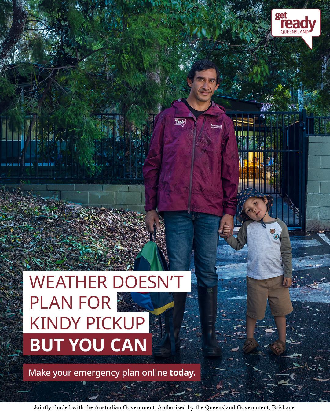 Man and young child standing at a school gate