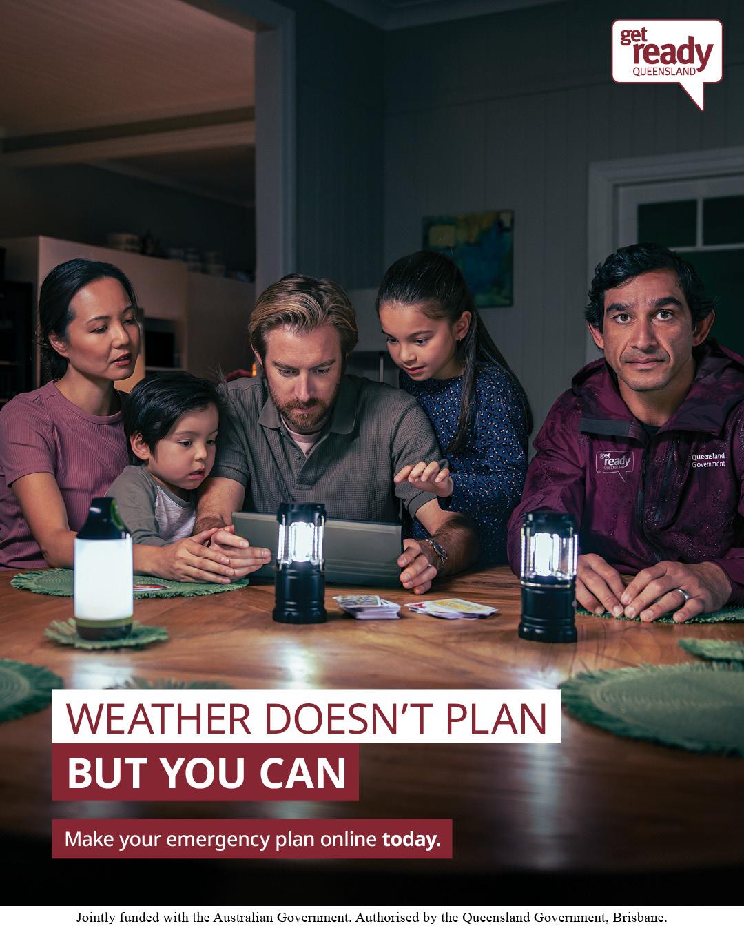 Family sat around a ipad at night with battery lamps on the table