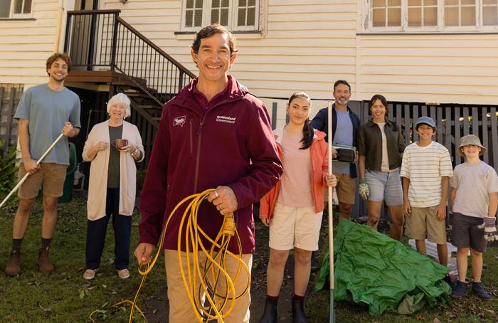 Queenslanders getting ready in front of Queenslander style house