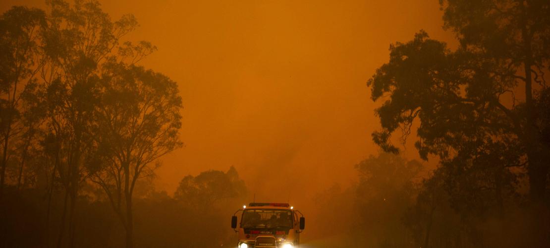 Fire truck driving near fire