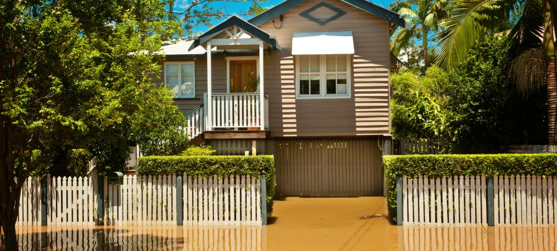 Queenslander house surrounded by flood water
