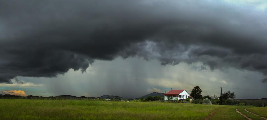 Farm house under stormy sky