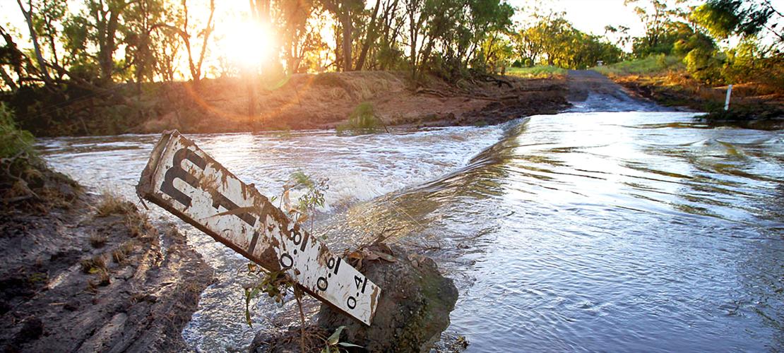 Flooded river with flood gauge