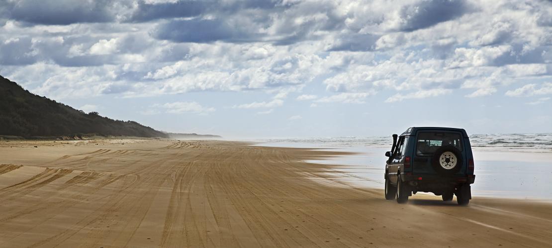 Car driving on beach