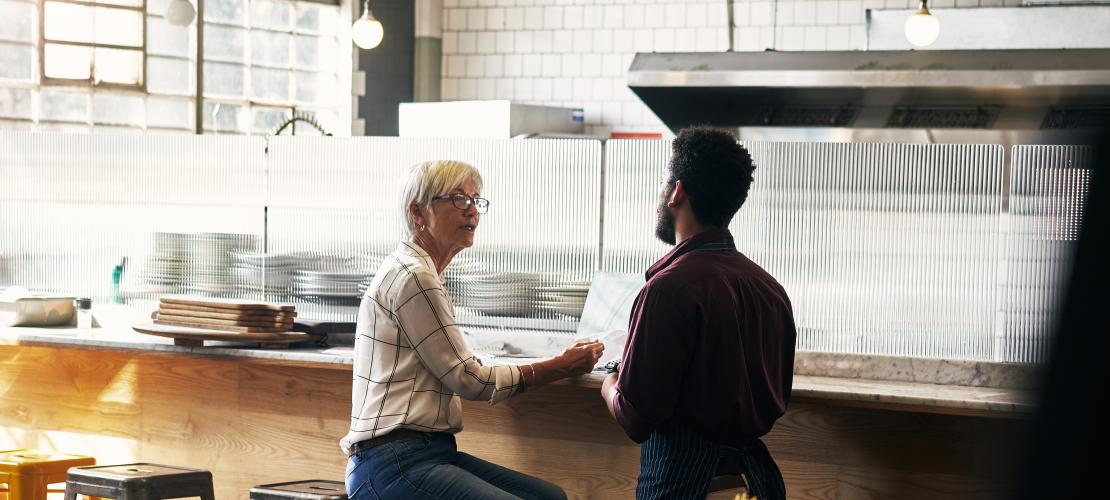 Man and woman talking in pizza restaurant