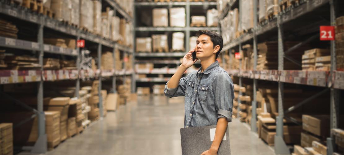 Man in warehouse on mobile phone