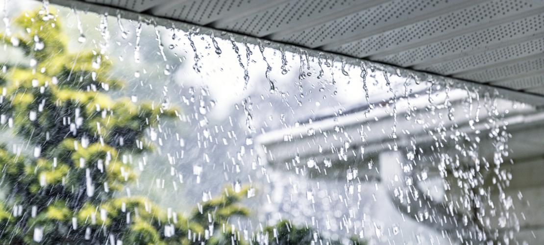 Heavy rain pouring off roof. 