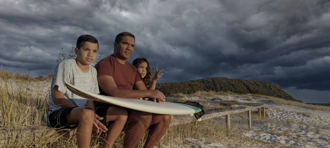 Family on a beach with storm in the background