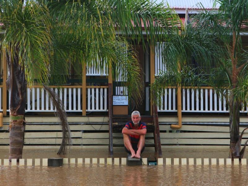 Man sitting on stairs in flood