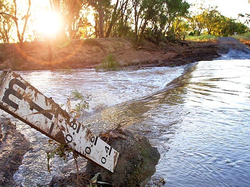 Flooded river with flood gauge