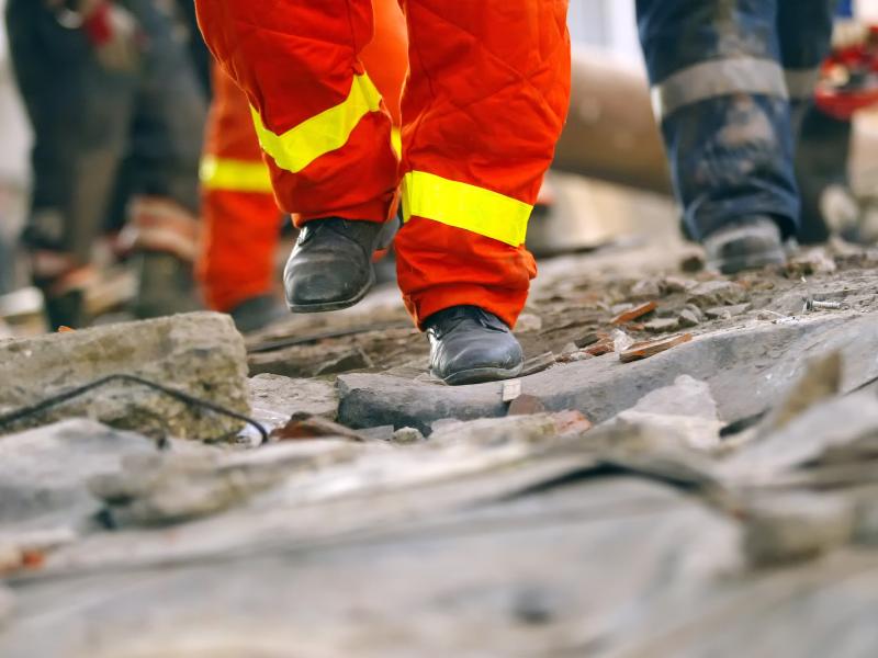 Emergency crew feet on broken road