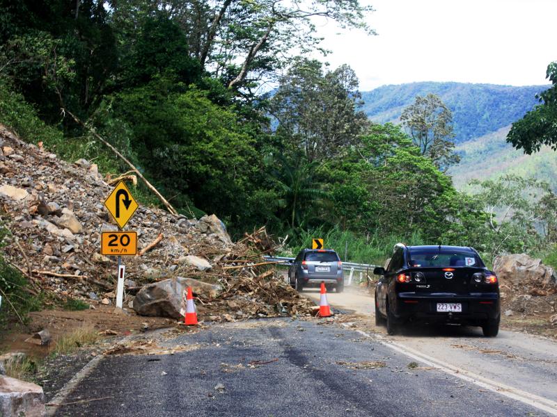 Cars driving past landslide