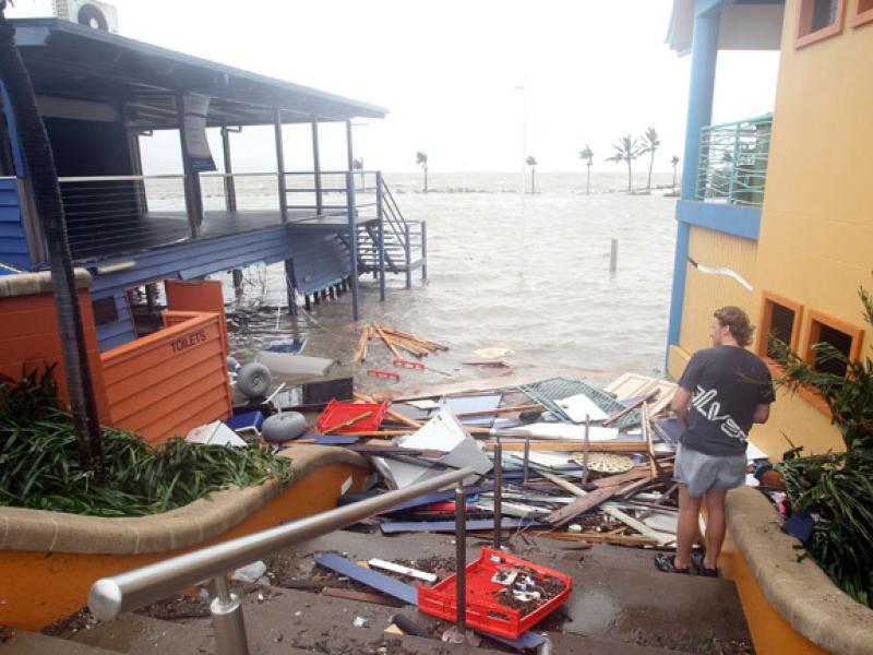 Man looking at flooded buildings
