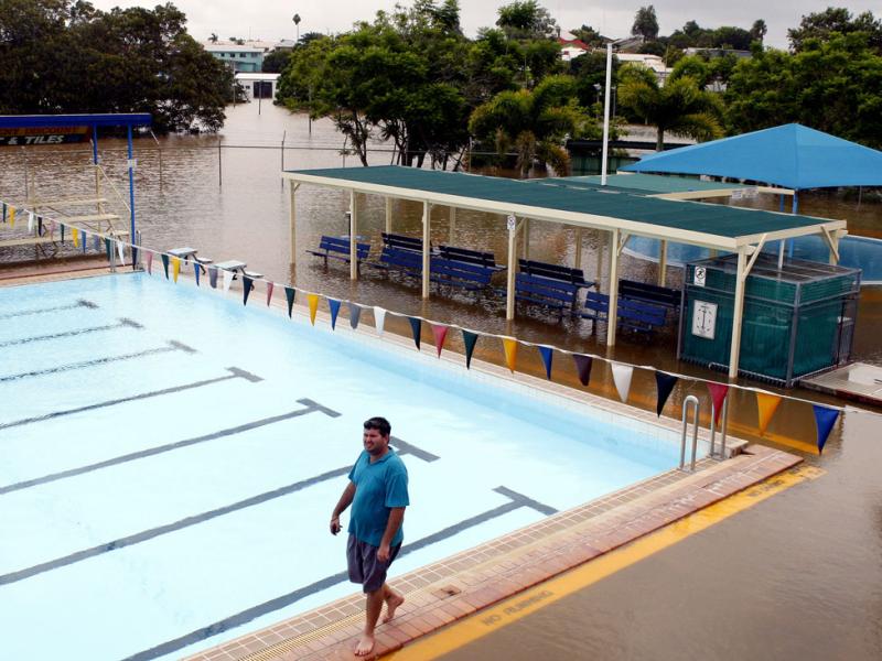 Man standing by flooded pool