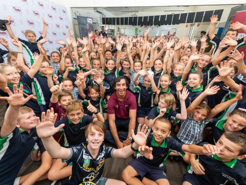 A photo of Johnathan Thurston with school kids.