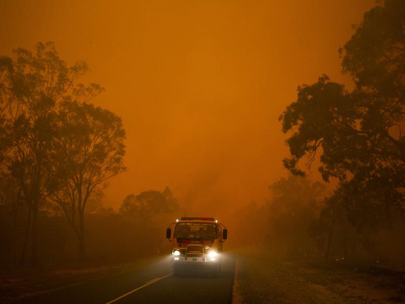 Fire truck in bushfire setting landscape